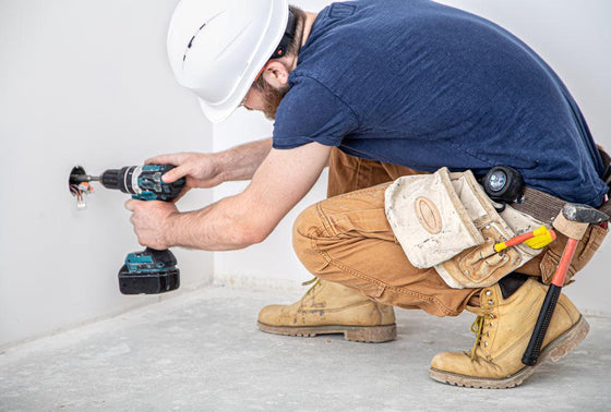 electrician-builder-work-installation-lamps-height-professional-overalls-with-drill-background-repair-site-concept-working-as-professional