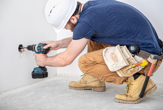electrician-builder-work-installation-lamps-height-professional-overalls-with-drill-background-repair-site-concept-working-as-professional